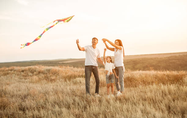 istock Happy family with kite in field 1279564468
