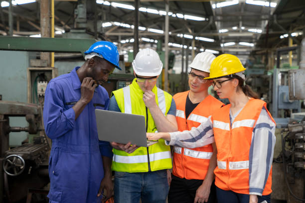 istock Female industrial engineers have to consult with colleagues while using laptop. 1279565513