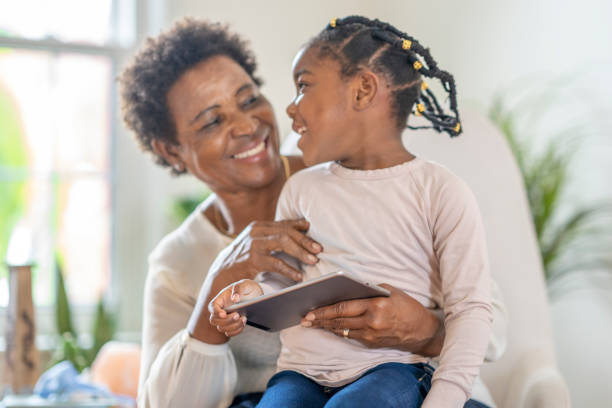 istock Grandmother using technology with granddaughter 1279567280
