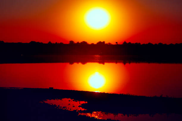 Sunset reflection in the lake water . Fantastic evening in the summer