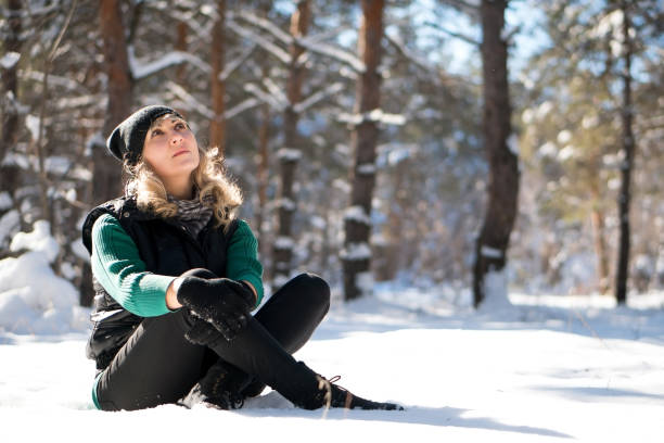 istock Model sits at snow in winter forest. 1279569319