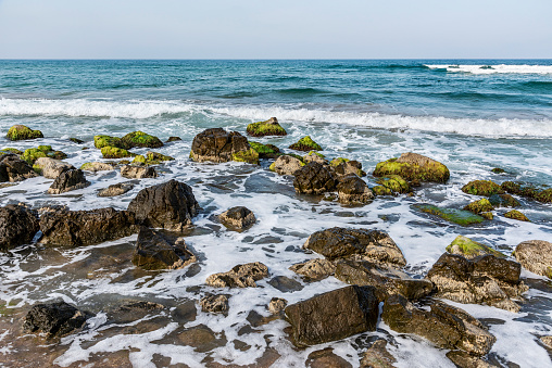 Rocky coastline and waves on the beach in Turkey.