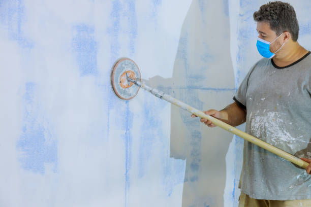 istock Man sanding the plaster plasterboard in drywall 1279574108