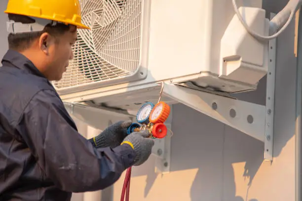 Photo of Technician use measuring equipment for filling air conditioners.