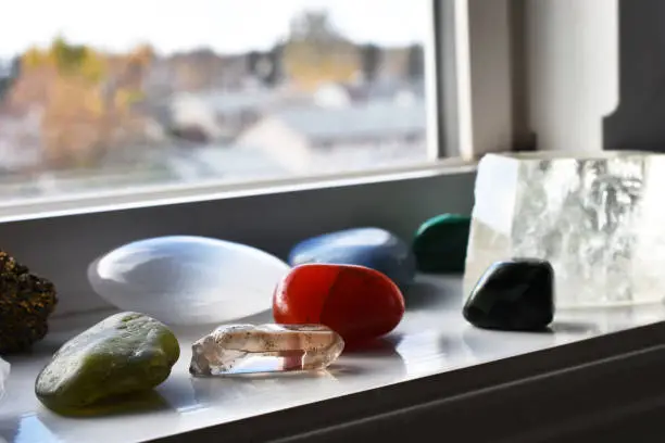 A close up image of healing crystals recharging on a windowsill.
