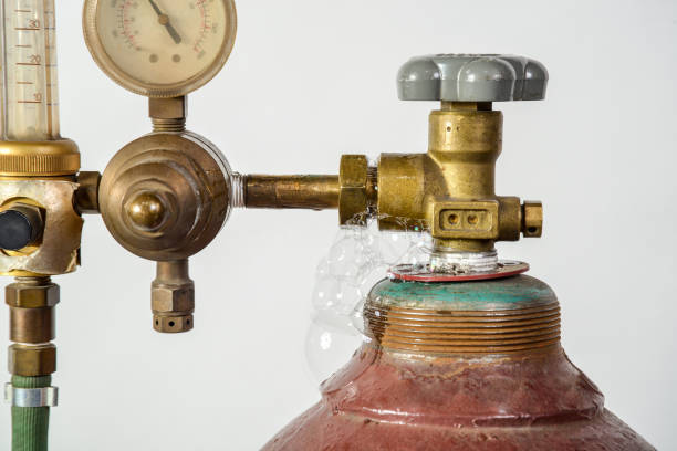 Leaking gas cylinder for industrial welding with dial, valve and nozzle