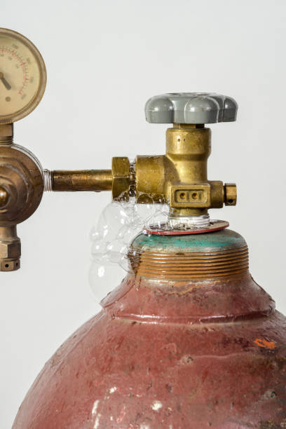 Leaking gas cylinder for industrial welding with dial, valve and nozzle