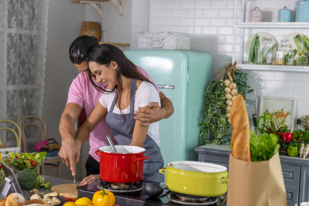 istock Happy family young couple cooking 1279578032
