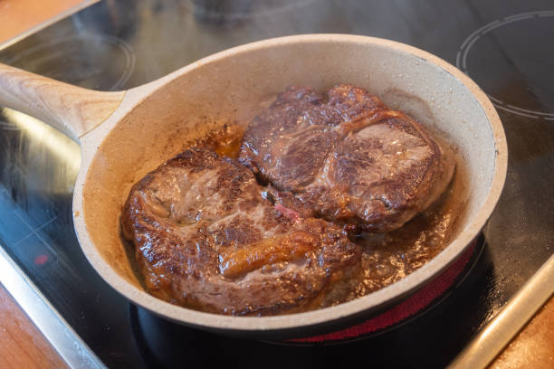 istock Meat concept. Pork loins chops fried in pan. Blur background, close up, above view. 1279584648