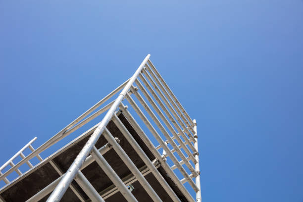 istock Scaffolding, metal mobile scaffold aginst blue sky background. 1279584659