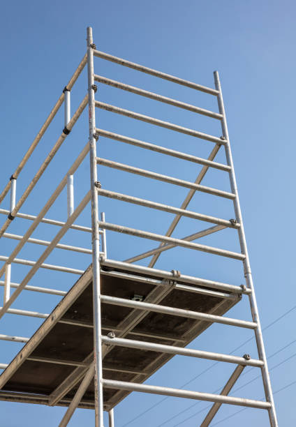 istock Scaffolding, metal mobile scaffold aginst blue sky background. 1279584669
