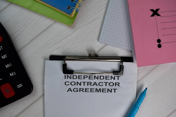 istock Independent Contract Agreement write on paperwork isolated on office desk. 1279586024