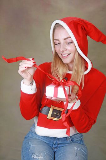 A pretty woman dressed as Santa during the Christmas season.