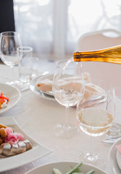 istock the waiter pours wine into a glass in a restaurant 1279588393