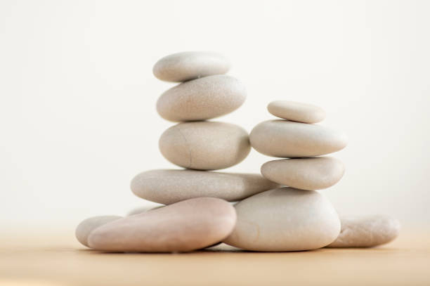 istock Two simplicity stones cairns isolated on white background, group of light white pebbles in tower 1279589194