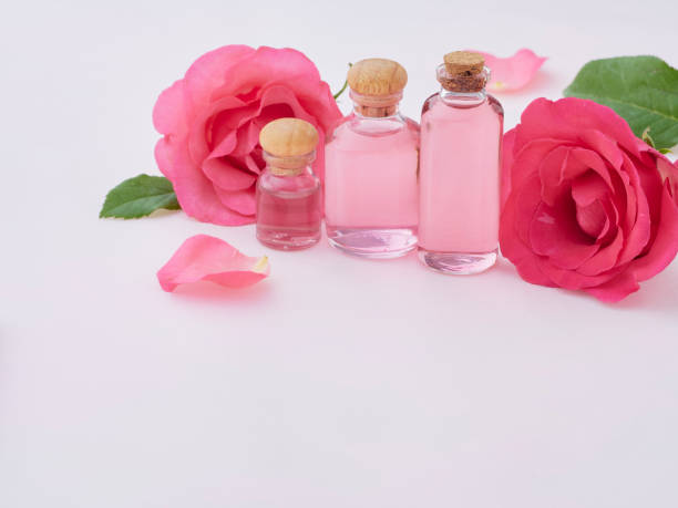 istock Aromatherapy oil bottles with roses on pink background 1279591584