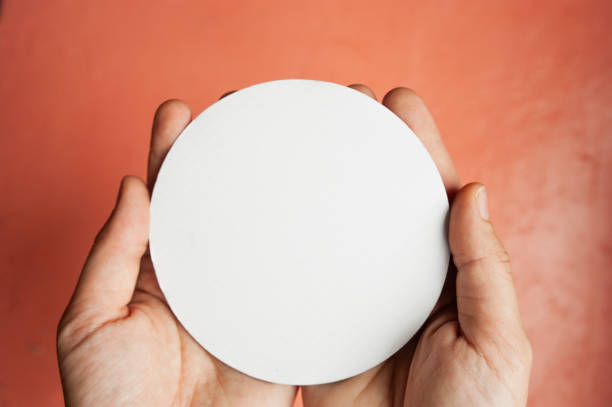 istock white empty circle for an inscription or logo in light-skinned hands on a pink background 1279593400