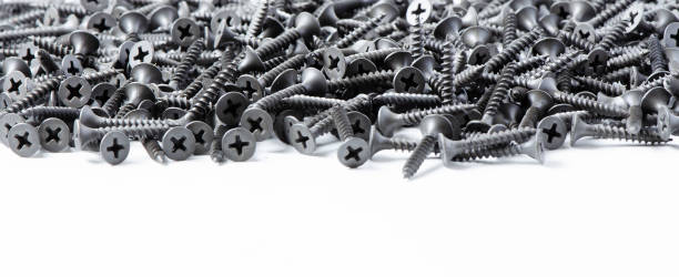 istock Lots of metal screws. White background. Copy space 1279596125