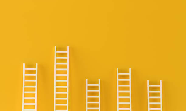 istock Ladder achievement collection on yellow wall. minimal studio background. 3d rendering 1279596352