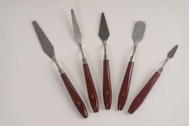 istock Five art palette knives lie on a white art canvas 1279601557
