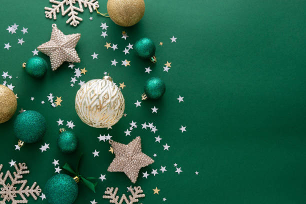 istock Christmas background with winter decorations, stars, baubles over green background. 1279603317