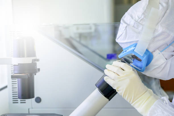 istock Lab scientists wear protective clothing looking for microscopes while doing medical research in a science laboratory. 1279606025
