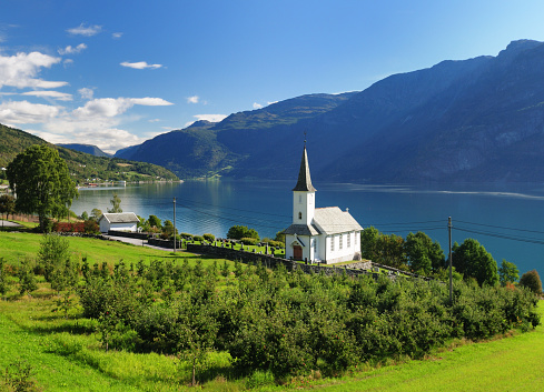 View To Lustrafjord With A White Wooden Chapel In The Foreground In Hoyheimsvik