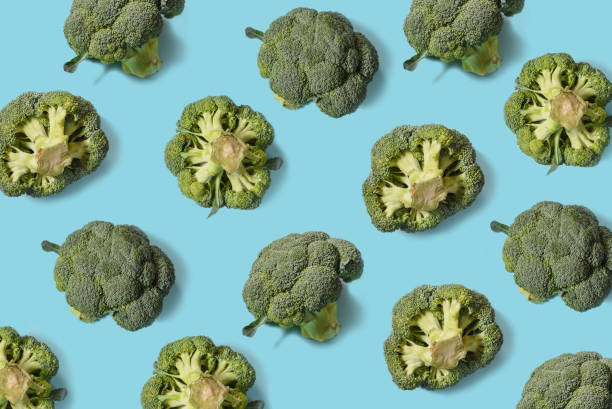 istock Top view of fresh broccoli isolated on blue background. Minimal concept. Flat lay 1279607095
