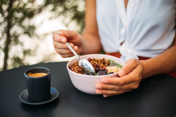 istock Woman eating smoothie bowl 1279607279