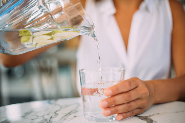 istock Pouring water in glass 1279607523