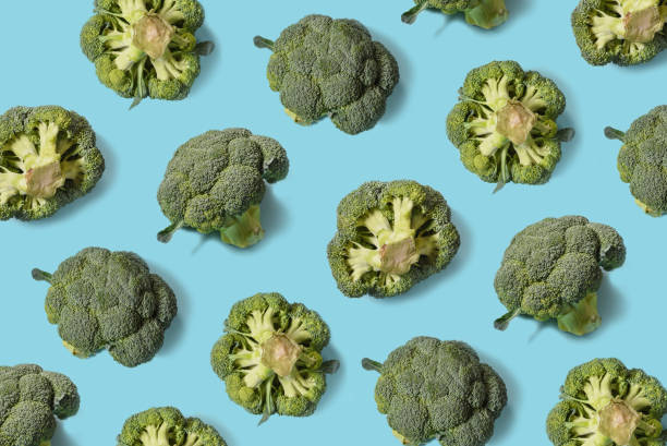 istock Top view of fresh broccoli isolated on blue background. Minimal concept. Flat lay 1279608503