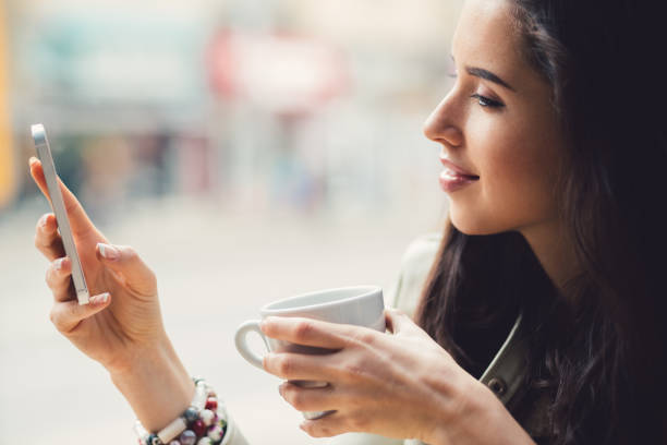 istock Woman in cafe using smartphone 1279610447