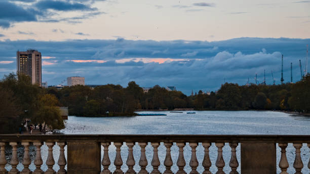 Sunset dusk view of the Serpentine from atop the Serpentine Bridge in Hyde Park