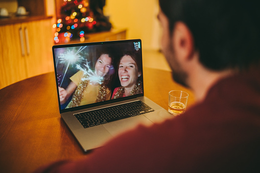 Group of friends in quarantine are making wishes for the Christmas holidays on video call