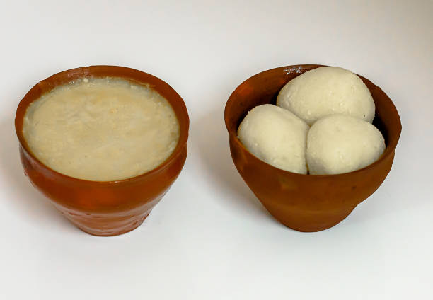 Sweet Roshogolla and Sweet curd Bengali Famous Sweet Roshogolla and Sweet curd or Mishty Doi,   served separately in earthen pot, selective focus is used. rosogolla stock pictures, royalty-free photos & images
