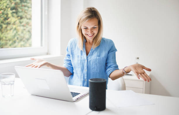 istock beautiful young woman is talking to a smart speaker 1279614486