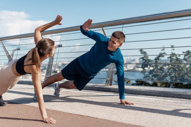 istock Man and woman making sport training outdoors together 1279617336