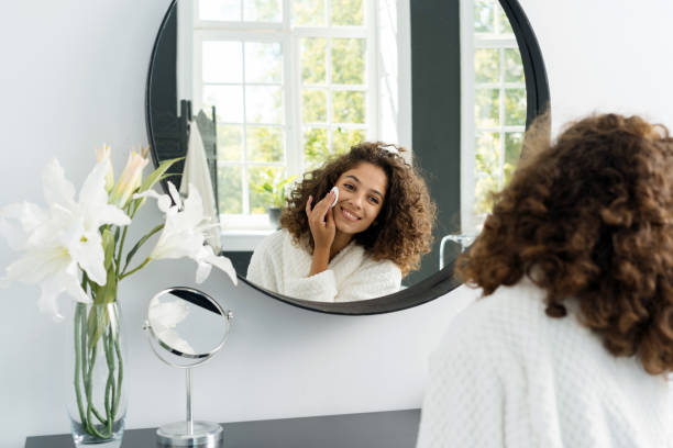 istock Young afro american woman in bathrobe at bathroom 1279617372