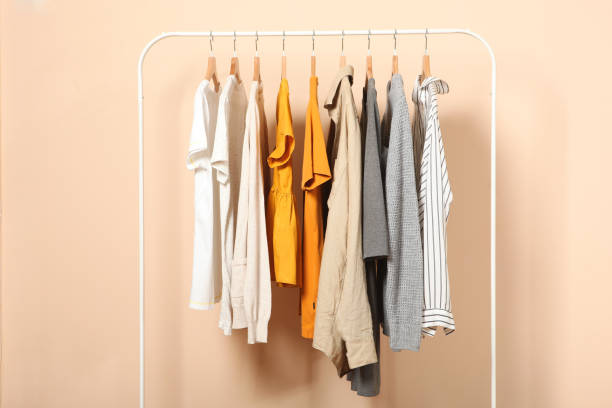 istock Fashionable clothes on hangers on a wardrobe rack. 1279617428