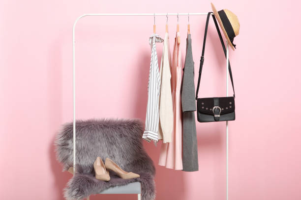 istock Fashionable clothes on hangers on a wardrobe rack. 1279617434
