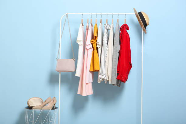 istock Fashionable clothes on hangers on a wardrobe rack. 1279617475