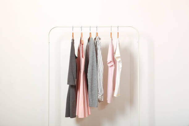 istock Fashionable clothes on hangers on a wardrobe rack. 1279617616