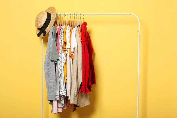 istock Fashionable clothes on hangers on a wardrobe rack. 1279618366