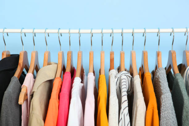 istock Fashionable clothes on hangers on a wardrobe rack. 1279618542