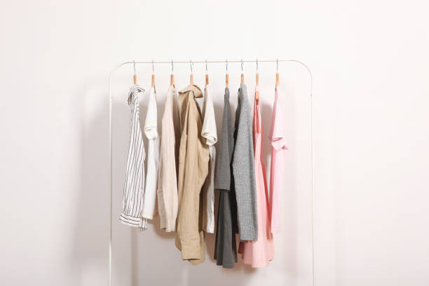 istock Fashionable clothes on hangers on a wardrobe rack. 1279618543