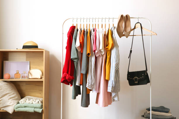 istock Fashionable clothes on hangers on a wardrobe rack. 1279619609