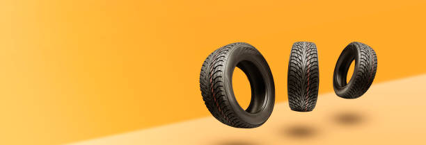 winter tires - panoramic concept with copyspace for the site header on a bright orange background. sale of tires or spare parts for the car stock photo
