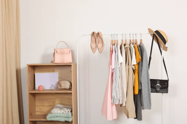 istock Fashionable clothes on hangers on a wardrobe rack. 1279619961