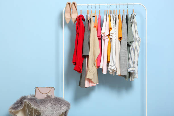 istock Fashionable clothes on hangers on a wardrobe rack. 1279619963