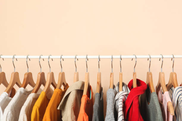 istock Fashionable clothes on hangers on a wardrobe rack. 1279619982